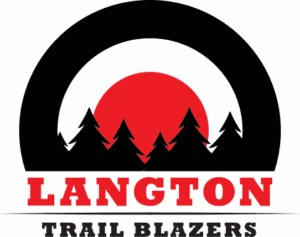 Image depicts setting sun behind tress with Langton Trail Blazers written in front.